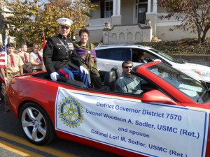 Lori and Woody Sadler representing the Rotarian Club in a parade
